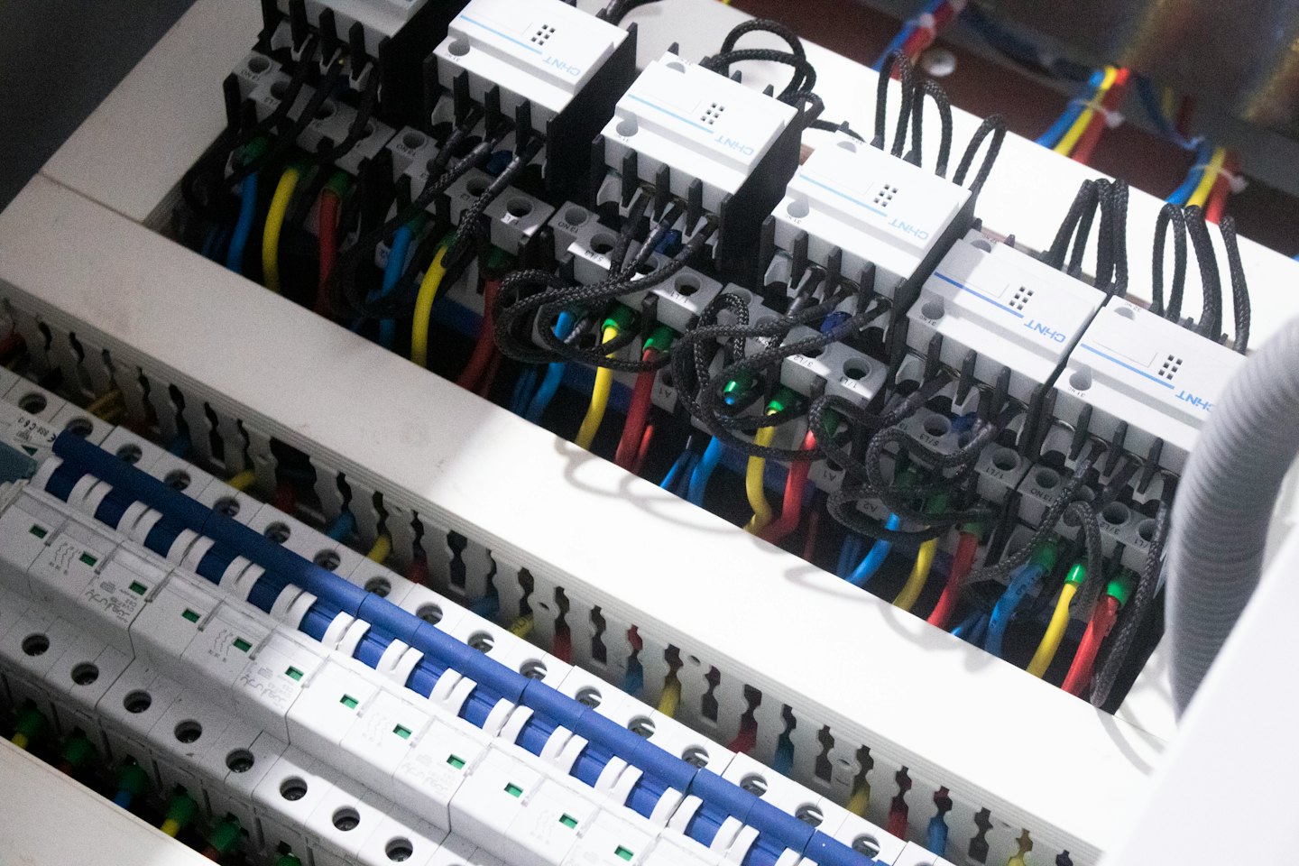 Booking Electrical control panel with circuit breakers and colorful wires.