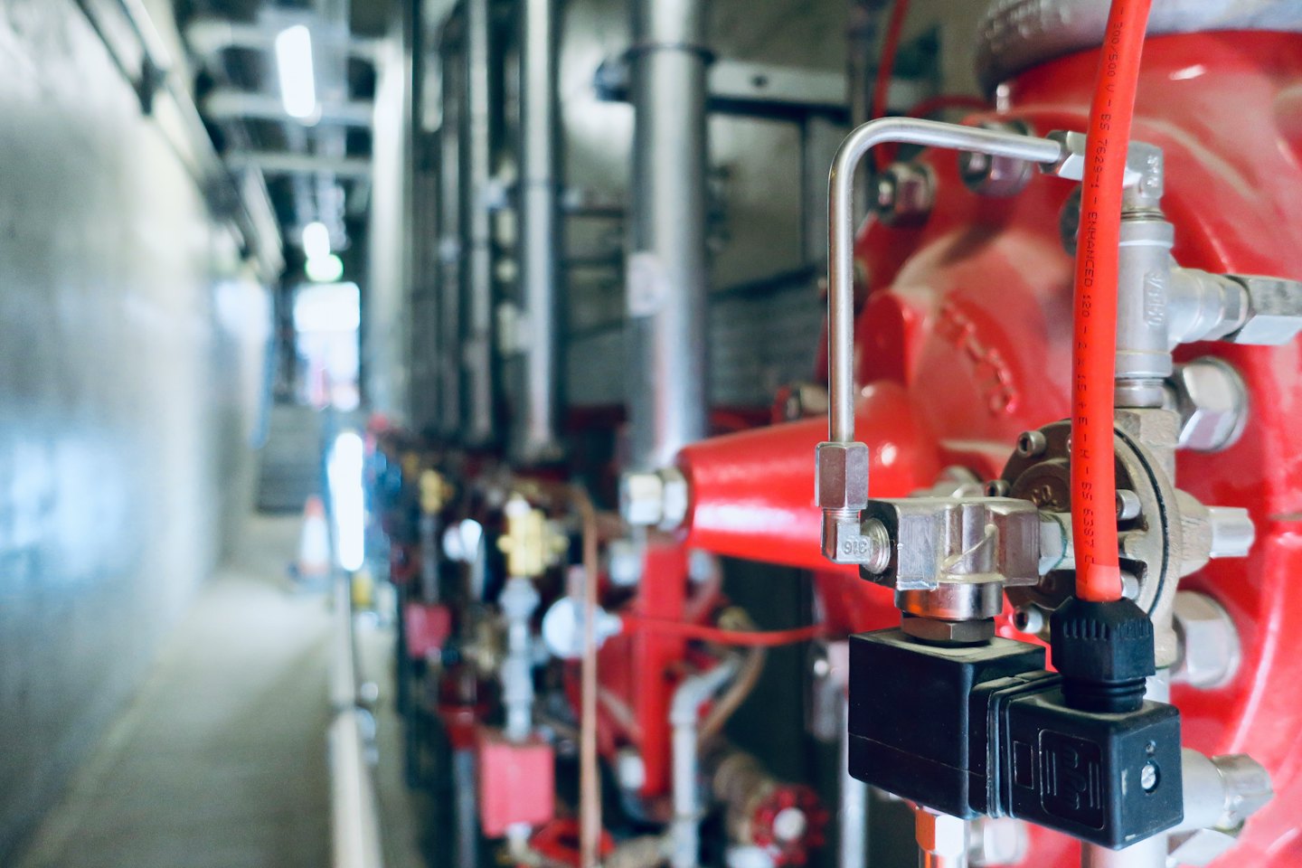 Portfolio Red industrial pipes and control systems in a utility space.